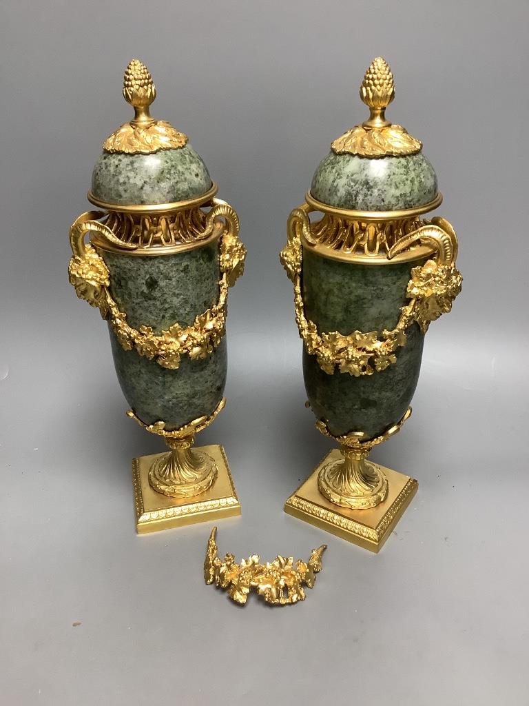 A modern pair of gilt metal and marble urns 32cm